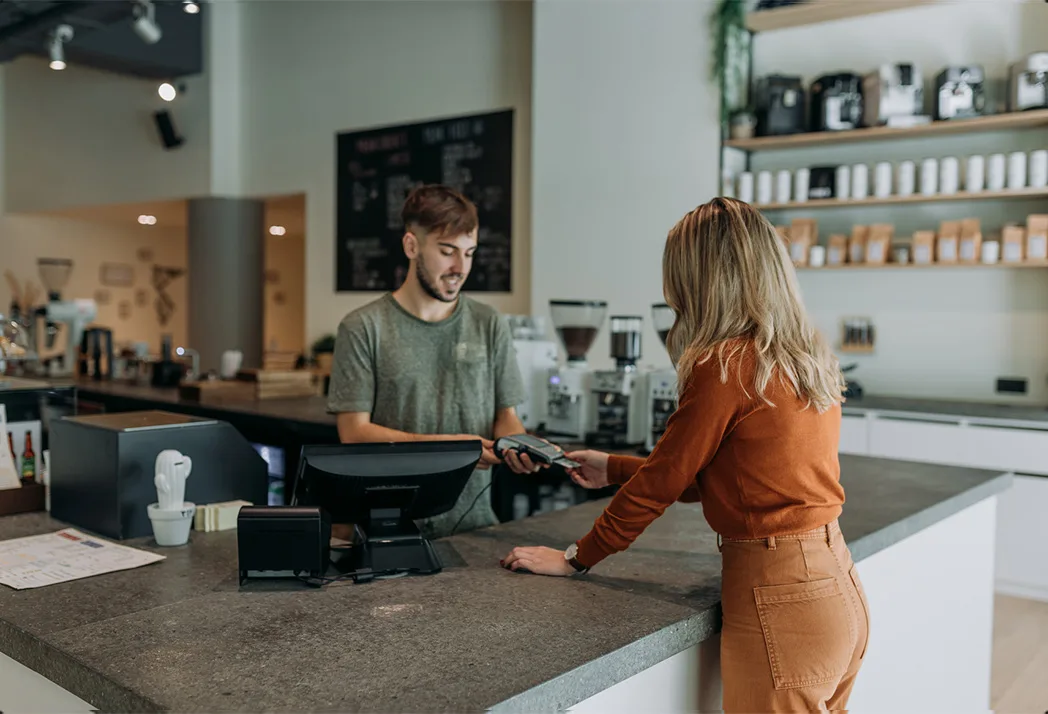 A woman paying in a café