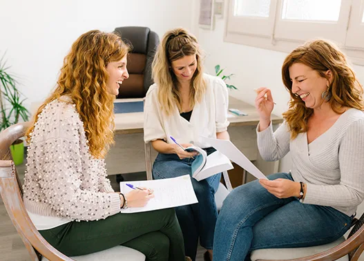 Three women, happy, working together